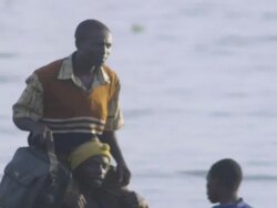 MS PAN People arriving by boat being carried ashore at lakeshore / Buikwe, Uganda Stock Footage