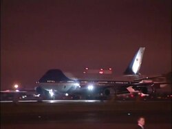 Air Force One lands at night at start of state visit Stock Footage