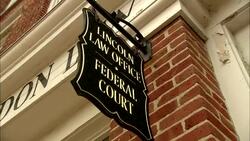 Lincoln Law Office Federal Court sign hanging from brick wall Stock Footage