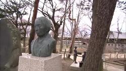 Busts mounted on plinths border a park in Japan. Stock Footage