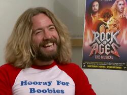 INTERVIEW Justin Lee Collins on wearing wigs and looking like Cher at the Rock of Ages Interviews at London England. (Footage by WireImage Video/Getty Images Entertainment Video) Stock Footage