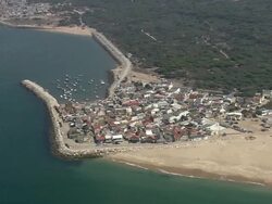 AERIAL WS Coastal village with harbor / Cova do Vapor, Setubal, Portugal Stock Footage