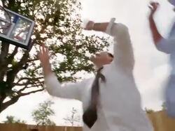 Low angle medium shot pan father and son playing basketball in driveway Stock Footage