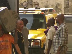 MS Shot of truck with people taking old televisions out of truck / Lagos, Nigeria Stock Footage