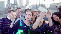 Young friends taking group selfie at urban rooftop party Stock Footage