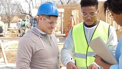 Foremen update charity executive on progress of home being built for charity Stock Footage