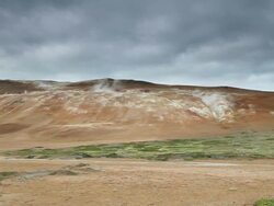 WS View of orange mountain which spewing volcanic steam at leirhnjukur / Krafla, Myvatn region, Iceland Stock Footage