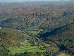 MS AERIAL View of church in town near river with autumn color trees / Massachusetts, United States Stock Footage