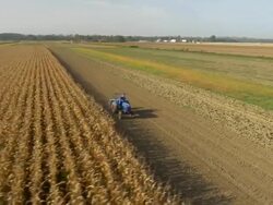 AERIAL Farmer Sowing The Field Stock Footage