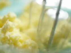 CU TU Shot of a woman using an electric whisk to blend a butter and flour mixture / Auckland, New Zealand Stock Footage