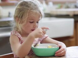  MS Girl eating bowl of pasta / Lamy, New Mexico, USA Stock Footage
