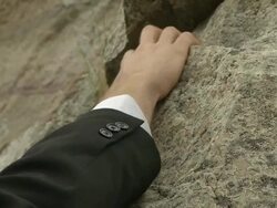 Businessman's hand reaches for grip. Stock Footage