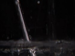 Light distortion in water shown by filling container with metal rod, (sound available) Stock Footage