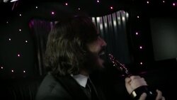 Proud celebrity in back of limousine shows off awards trophy to paparazzi and cheers at awards show Stock Footage