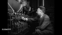 1946: SCIENTISTS &amp; NOBEL LAUREATES: Chemist Harold C. Urey (1893-1981) working w/ tubing on table. Physicist Ernest O. Lawrence (1901-1958) adjusting knobs on pipes w/ pressure gauges. Instructional Video