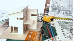 Architects workspace with house model & blue print Stock Footage