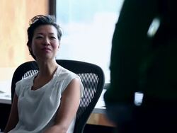 MS Businesswoman sitting in office workstation in discussion with coworker standing in doorway/Washington, USA Stock Footage