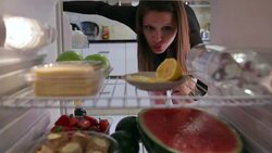 Young woman  takes orange juice, cheese, avocado from the fridge Stock Footage