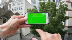 Man swiping a smartphone with a green screen Stock Footage