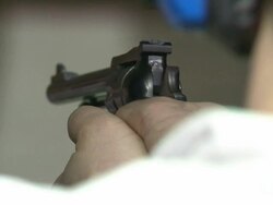 Man Loads Revolver and Fires at a Target Stock Footage