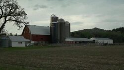 Wisconsin dairy farm under heavy clouds Stock Footage