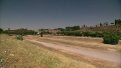 Traffic moves on a highway next to Rome's ancient Circus Maximus. Stock Footage