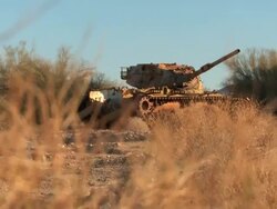 WS ZI Broken down tank in the desert Stock Footage