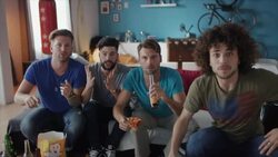 Guys sitting on couch watching tv and cheering Stock Footage