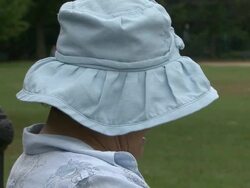 Head shaking senior sitting in a park Stock Footage