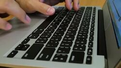 Man is Typing on Laptop Keyboard on Wood Table, Dolly Shot Stock Footage