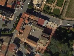 AERIAL OH WS ZO View over rooftops with church in town center / Fleurie, France Stock Footage