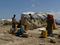 MS Woman spin and drying laundry in refugee camp with boy / Djibouti Stock Footage
