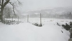 Snow drifts below Wansfell, Lake District, UK, following the unseasonal extreme weather of late March 2013. Stock Footage
