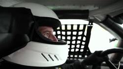 Stock-car driver grips steering wheel, eyes focus on race Stock Footage