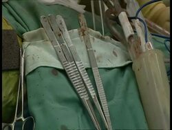 CU Gloved hand returning bloodied surgical forceps and selecting different ones Stock Footage