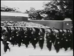 B/W 1950s PAN women in black uniforms marching in parade / North Vietnam / newsreel Stock Footage