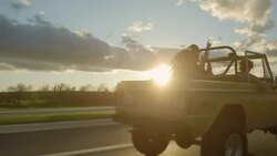 Friends driving classic Bronco throw hands in the air and cheer Stock Footage