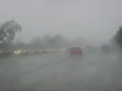 Heavy Downpour on the 405 Freeway, Southern California, United States. Car braking heavily Stock Footage