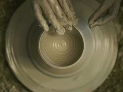 CU Shot of female potter shaping  pot from lump of clay on potters wheel at pottery / Kyoto, Japan Stock Footage