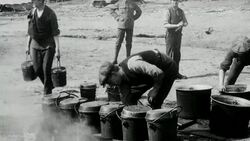 1921 MONTAGE Soldiers of the London Scottish reserve regiment, wearing half uniform and half civilian clothing, cooking and eating at base camp on Wimbledon Common / London, England Stock Footage