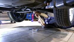 Car mechanic working under a vehicle. Stock Footage