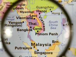 Magnifying glass over Southeast Asia map Stock Footage