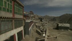 Mountains surround buildings and houses in Tibet. Stock Footage