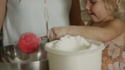Close up shot of mother and daughter measuring flour for baking / Orem, Utah, United States Stock Footage