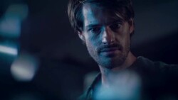 Man in motorcycle workshop looking at his bike Stock Footage