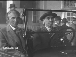 1920s: AUTO INDUSTRY: LA WS 15 Millionth Model T automobile car at end of production line, Henry Ford sitting in car w/ unidentified male, driving car off assembly line. WS Vintage Ford autos & 15 Millionth car, Henry Ford sitting in his first car. Instructional Video