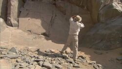 An archaeologist takes photos at an ancient quarry in Wadi Hammamat. Stock Footage