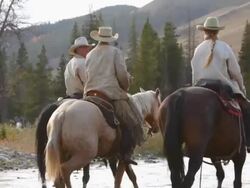 Cowboys and Cowgirl crossing river on horseback Stock Footage