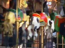 Parent Riding Merry Go Round Carrousel with Child Stock Footage