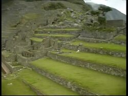 Machu Picchu, pan left  from industrial zone to temple of 3 windows, WA, Peru Stock Footage